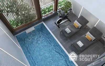 Luxurious indoor pool with lounge chairs and exercise bike, perfect for relaxation and fitness.