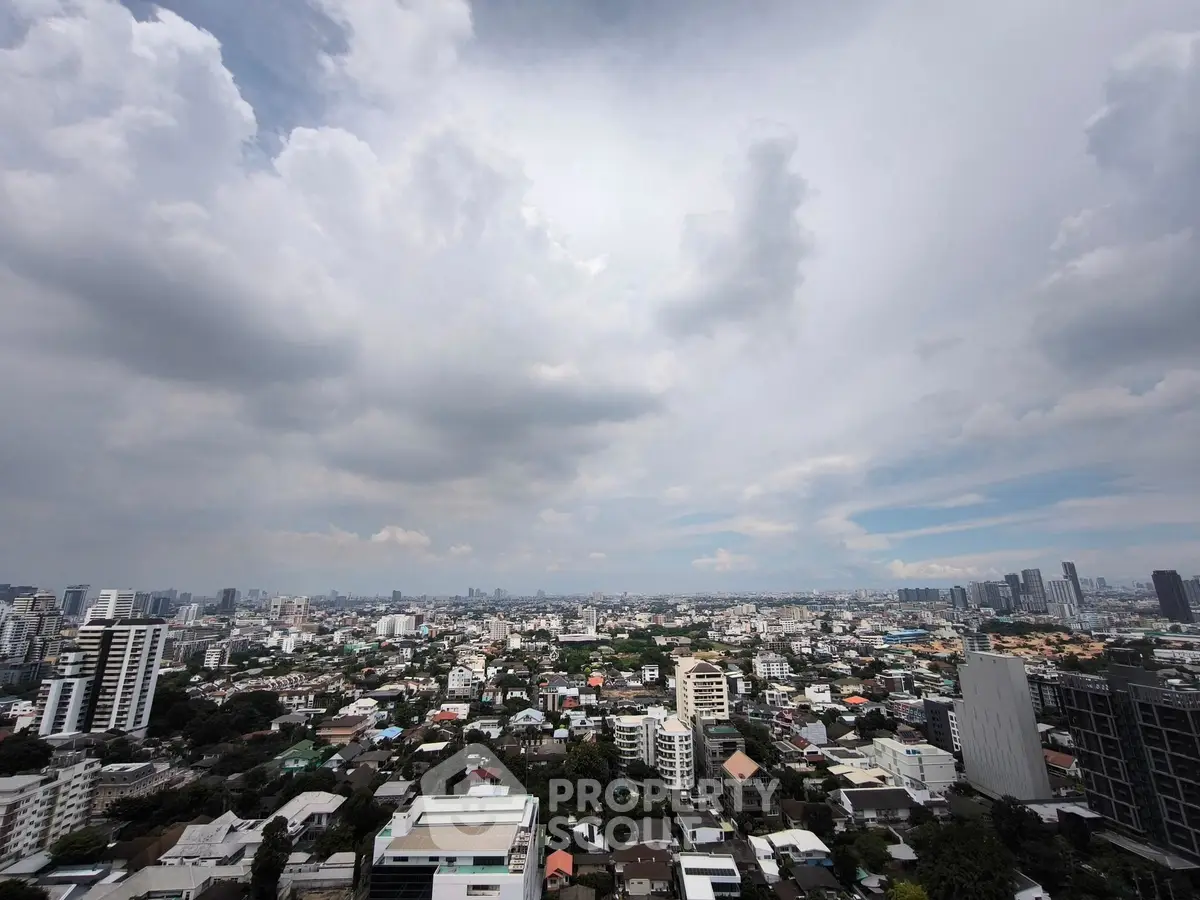 Stunning cityscape view showcasing urban skyline under a dramatic cloudy sky.