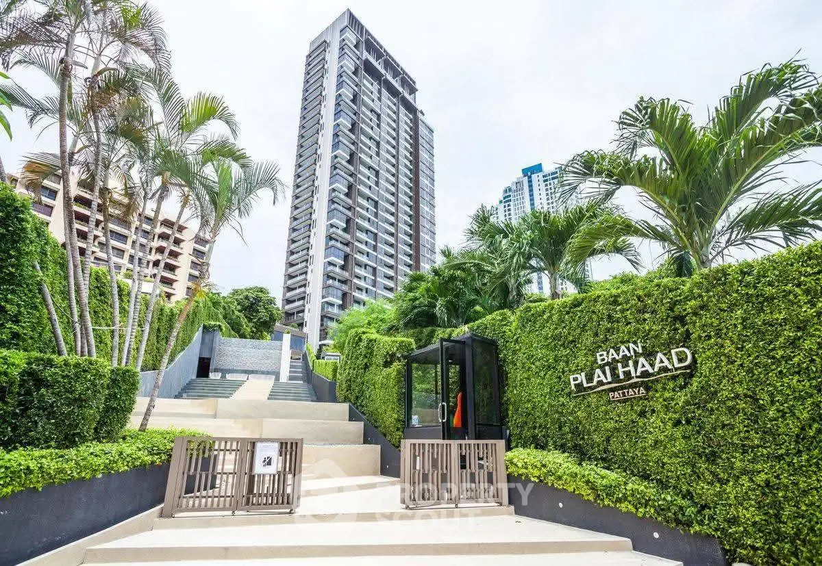 Luxurious high-rise building with lush green entrance in Pattaya
