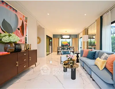 Luxurious living room with elegant decor and spacious layout, featuring modern furniture and vibrant artwork.