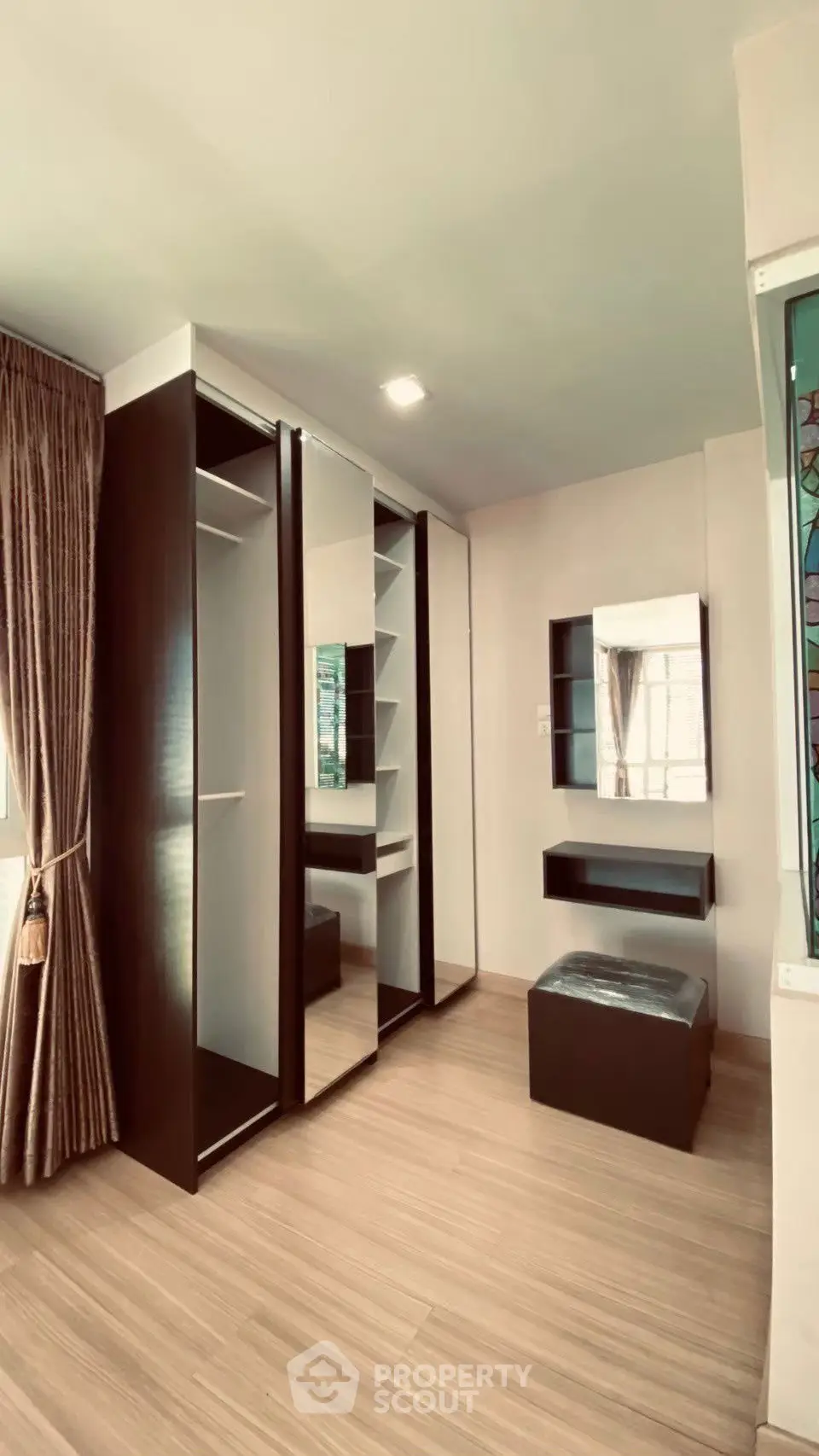 Spacious bedroom with modern walk-in closet and elegant decor