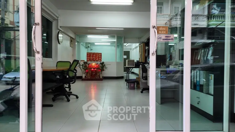 Modern office space with glass doors and open layout in urban setting