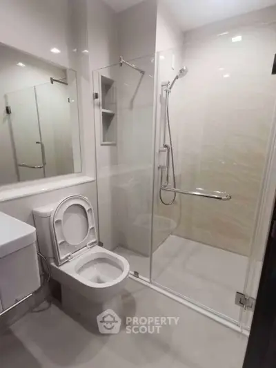 Modern bathroom with glass shower enclosure and sleek fixtures