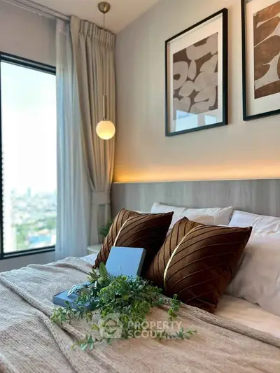 Luxurious bedroom with elegant decor and large window offering stunning city views.