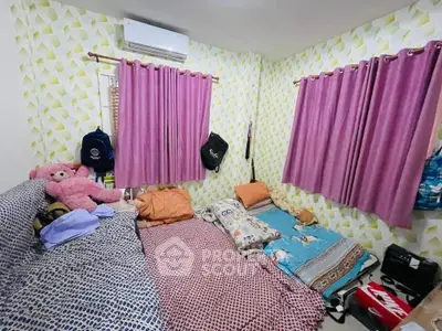Cozy bedroom with colorful bedding and air conditioning unit