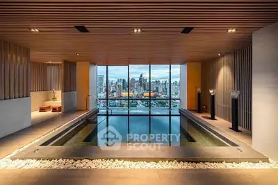 Luxurious indoor pool with stunning city skyline view, perfect for relaxation and entertainment.