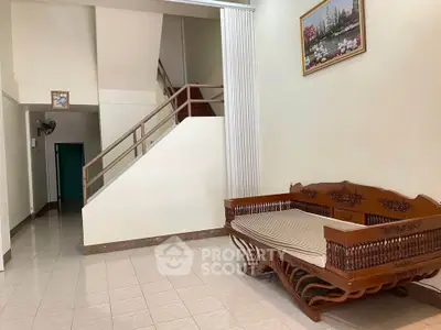 Spacious interior with elegant wooden furniture and staircase, perfect for a cozy living area.