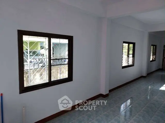 Spacious interior with large windows and tiled flooring, perfect for natural light and open living.