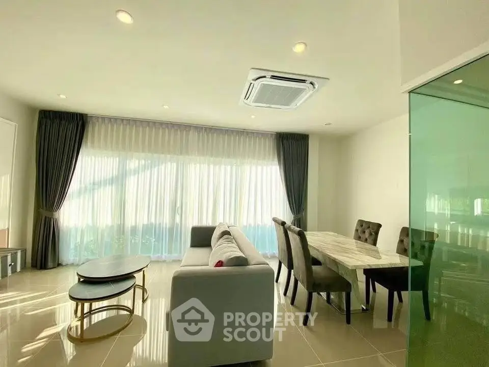 Spacious living room with modern furniture and large windows for natural light.