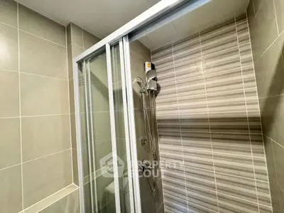 Modern bathroom with sleek shower enclosure and stylish tile design.