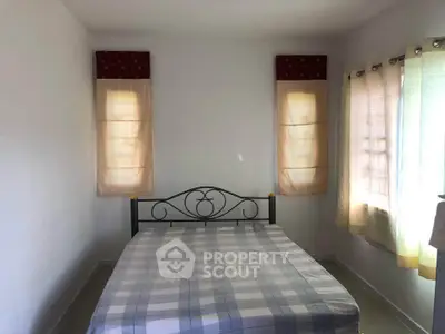 Cozy bedroom with natural light and simple decor, perfect for a peaceful retreat.