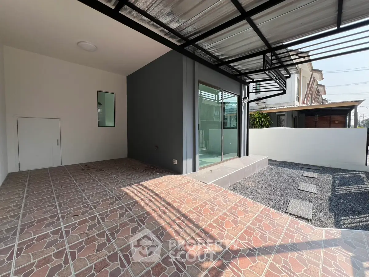 Modern home exterior with covered patio and stylish tile flooring