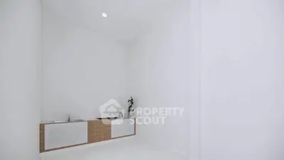 Minimalist kitchen with sleek cabinetry and modern design in a bright, spacious room.