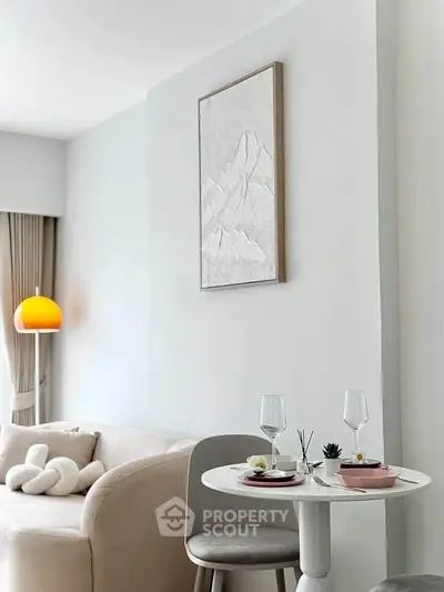 Stylish modern living room with cozy sofa and elegant dining setup, perfect for urban living.