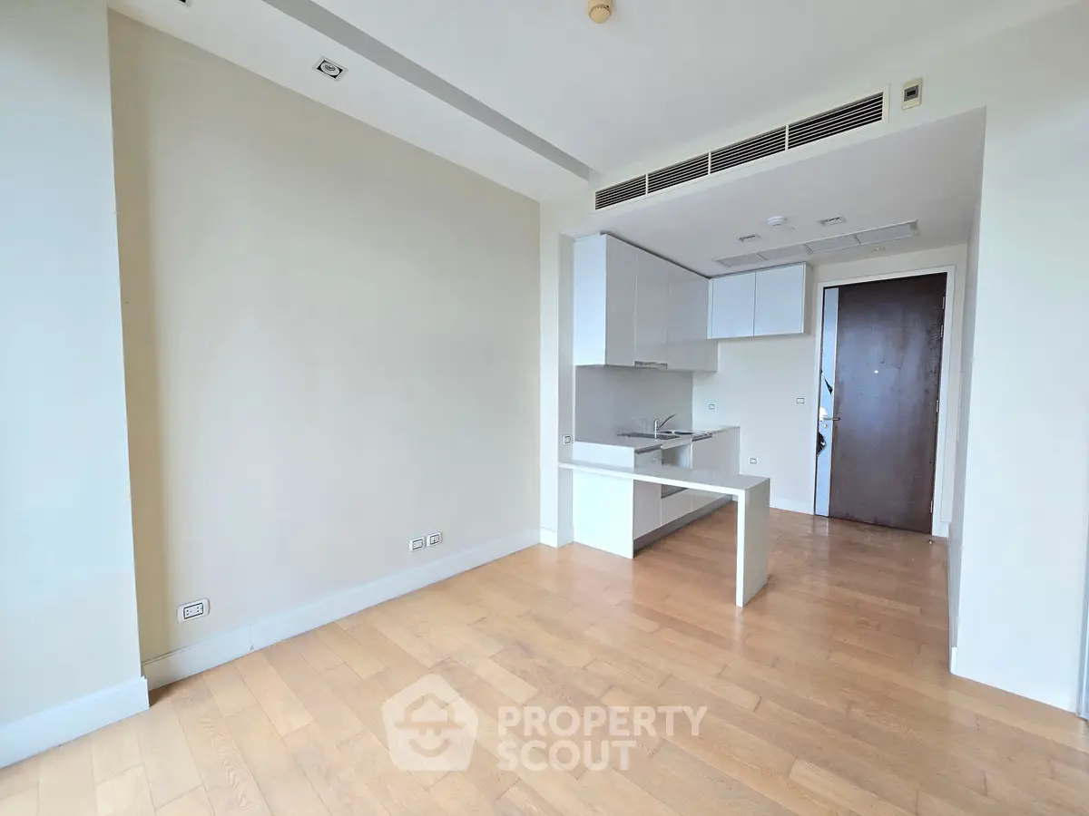 Modern apartment with open kitchen layout and wooden flooring, perfect for contemporary living.