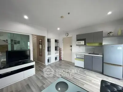 Modern open-layout living room with sleek kitchen and stylish decor