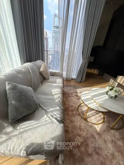 Luxurious living room with plush sofa, elegant curtains, and stunning city view.