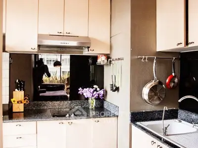 Modern kitchen with sleek countertops and stainless steel appliances, perfect for culinary enthusiasts.