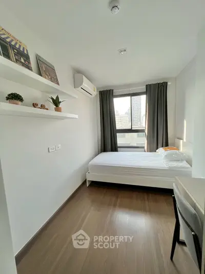 Modern minimalist bedroom with city view, featuring sleek design and natural light.
