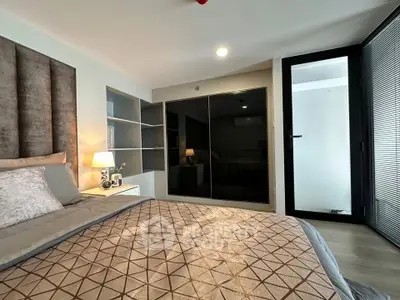 Modern bedroom with stylish decor and ample storage in a contemporary apartment.