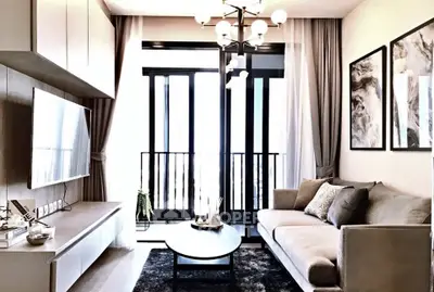 Modern living room with elegant decor and balcony view, featuring stylish furniture and chic lighting.