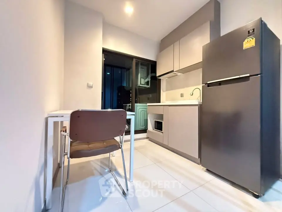 Modern kitchen with sleek appliances and minimalist design, featuring a spacious fridge and stylish cabinetry.