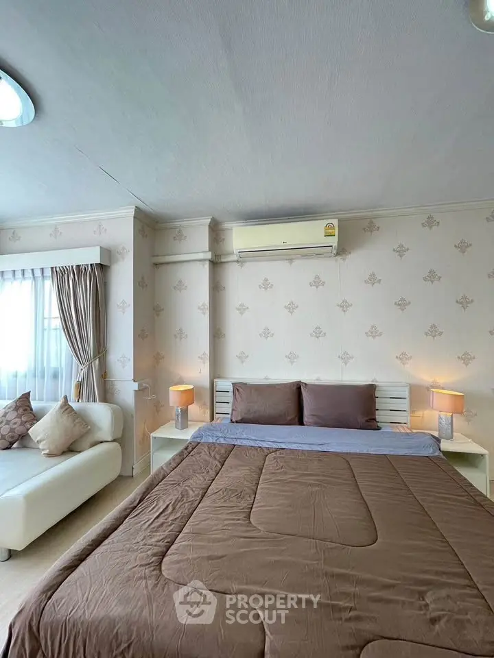 Cozy bedroom with elegant decor and natural light, featuring a comfortable bed and stylish furnishings.