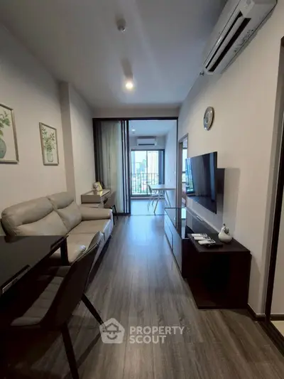 Modern living room with sleek furniture and city view balcony
