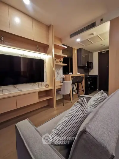 Modern living room with sleek furniture and integrated kitchen area, perfect for urban living.