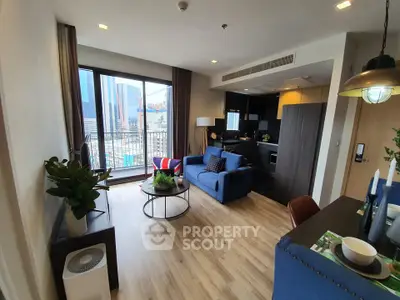 Modern living room with open kitchen and city view balcony in a stylish apartment.