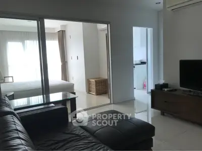 Modern apartment living room with sleek furniture and natural light