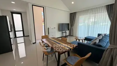 Modern living room with sleek furniture and large windows in a stylish apartment.