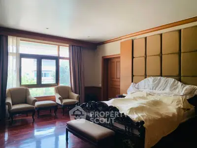 Luxurious bedroom with elegant wooden furniture and large window view