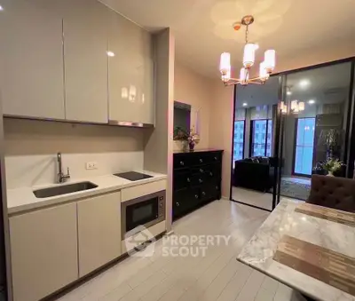 Modern kitchen with sleek cabinetry and dining area in a stylish apartment