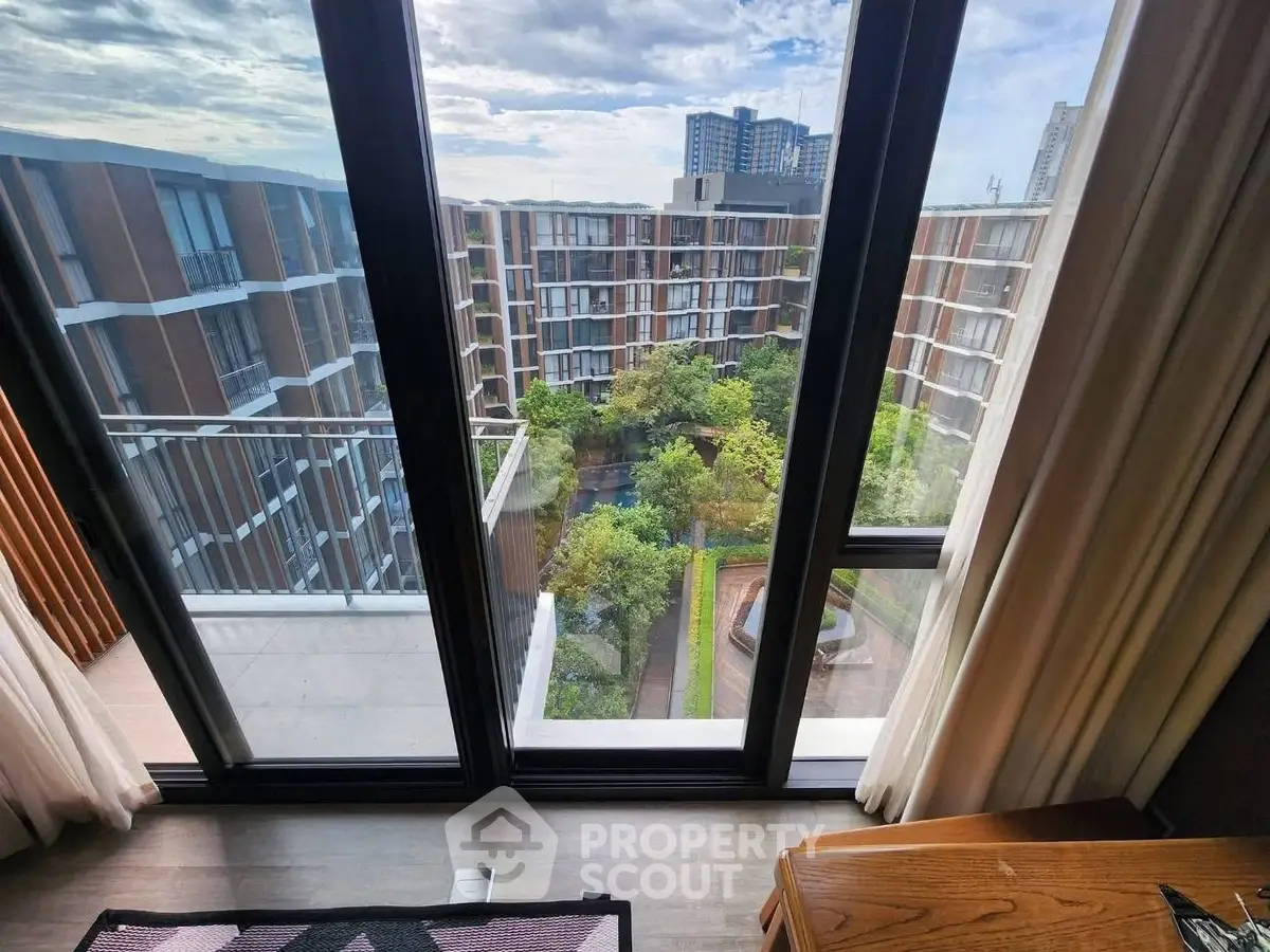 Stunning balcony view of modern apartment complex with lush garden