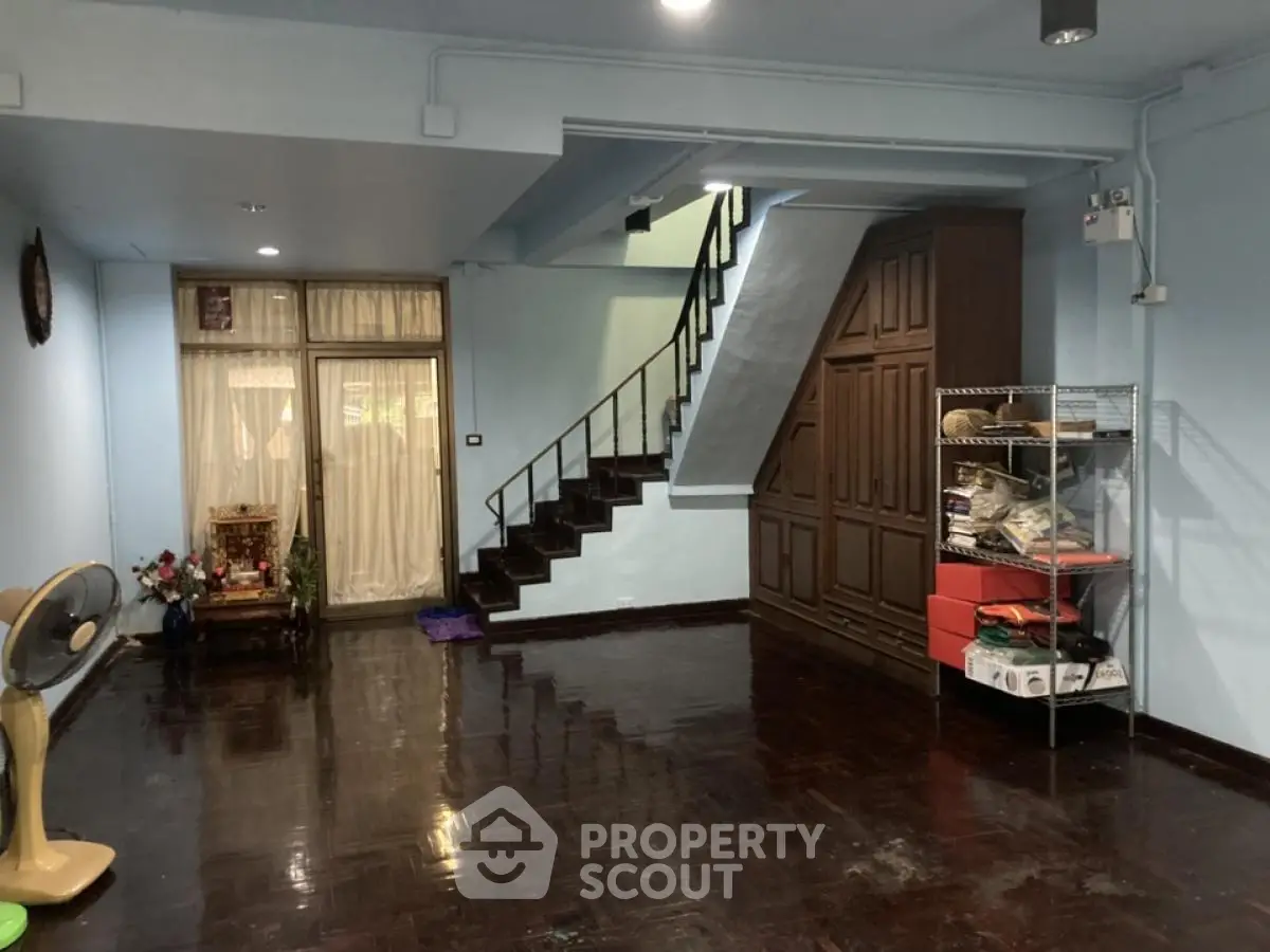 Spacious interior with wooden staircase and storage, ideal for customization