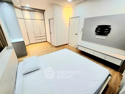 Modern bedroom with sleek design and ample storage space