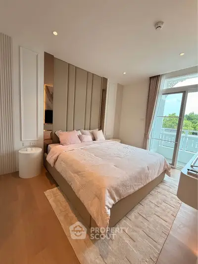 Luxurious bedroom with elegant decor and balcony view, featuring plush bedding and modern design elements.