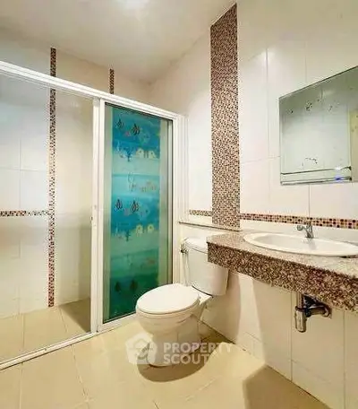 Modern bathroom with glass shower and elegant tile accents
