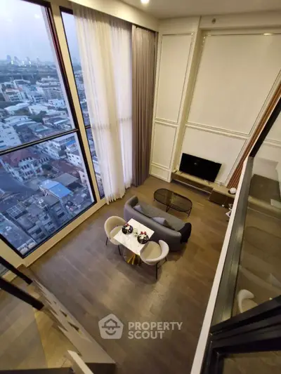 Stunning high-rise living room with floor-to-ceiling windows and breathtaking city view.