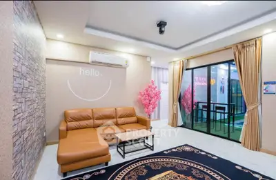 Stylish living room with modern decor and large sliding glass doors leading to a balcony.
