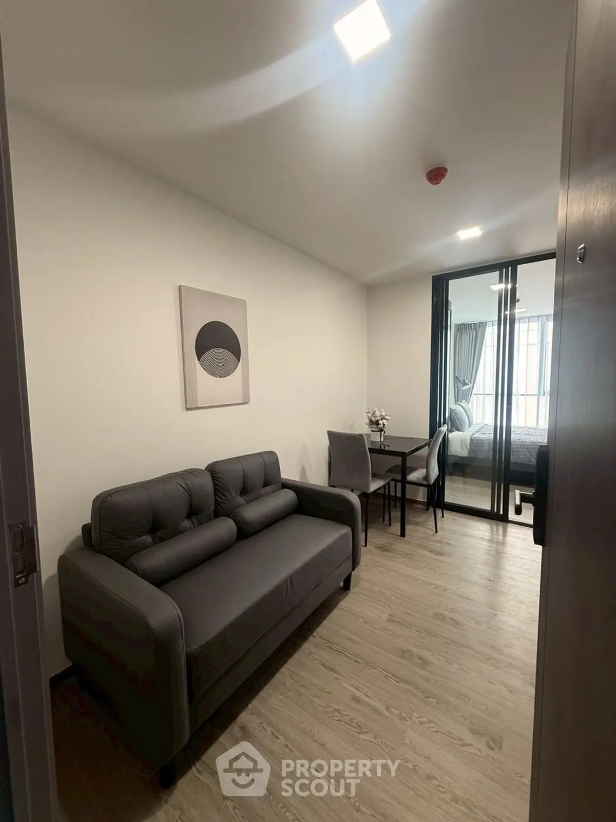 Modern compact living room with sleek furniture and dining area