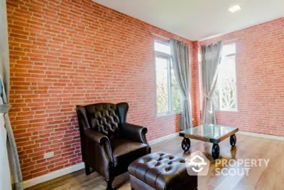 Stylish living room with brick accent wall and leather furniture