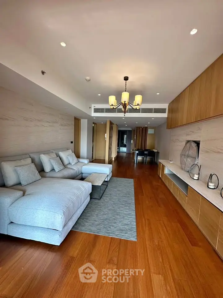Spacious modern living room with wooden flooring and elegant furniture
