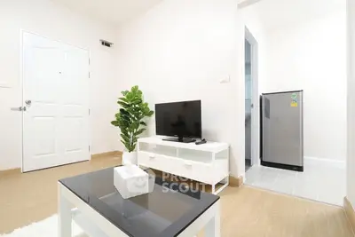 Modern living room with TV and sleek decor in a bright apartment