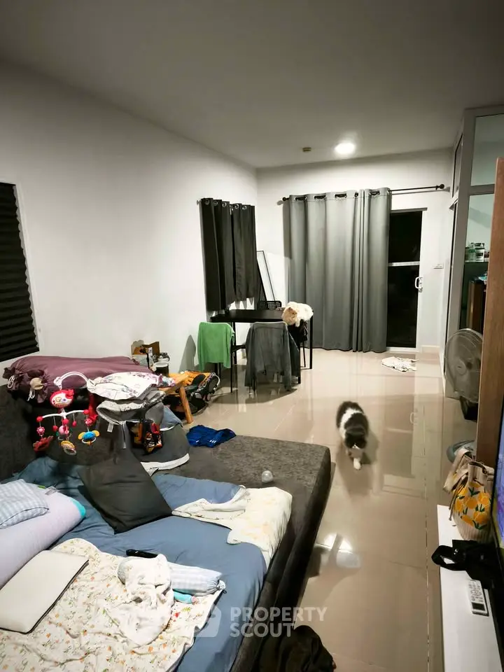 Spacious living room with modern decor and large windows, perfect for relaxation and entertainment.