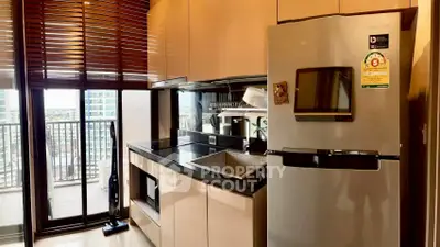 Modern kitchen with sleek appliances and balcony view