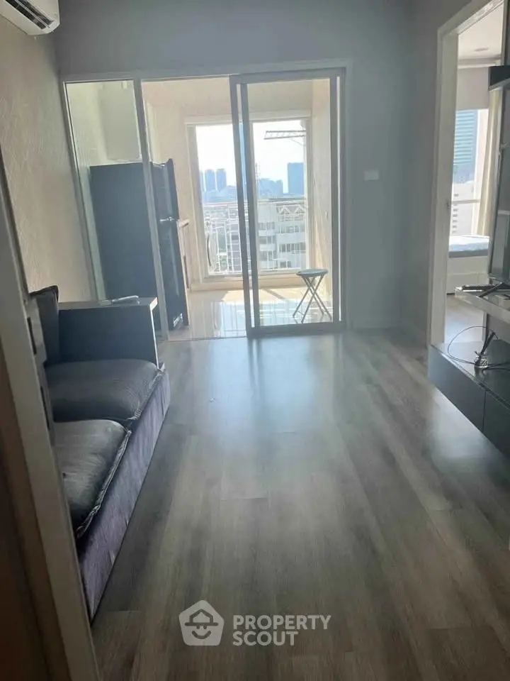 Modern apartment with spacious living room and balcony view.