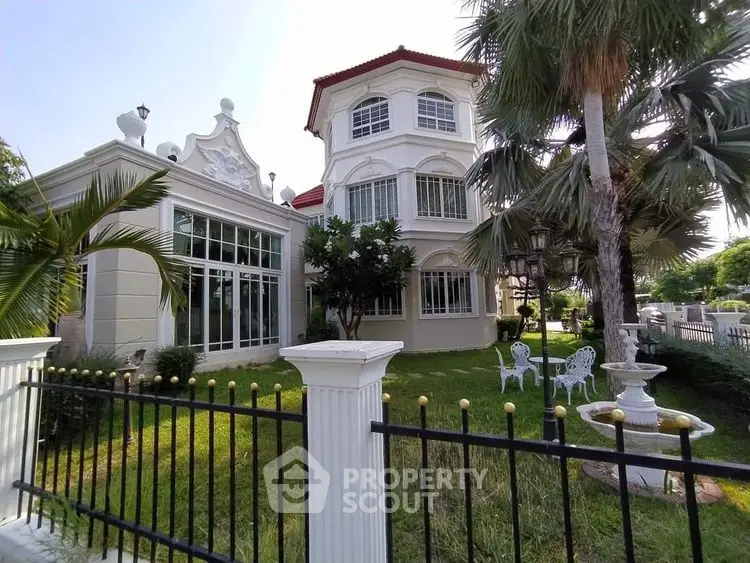 Elegant two-story house with lush garden and classic architectural design