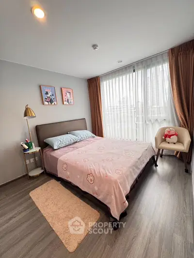 Cozy bedroom with modern decor and large window for natural light